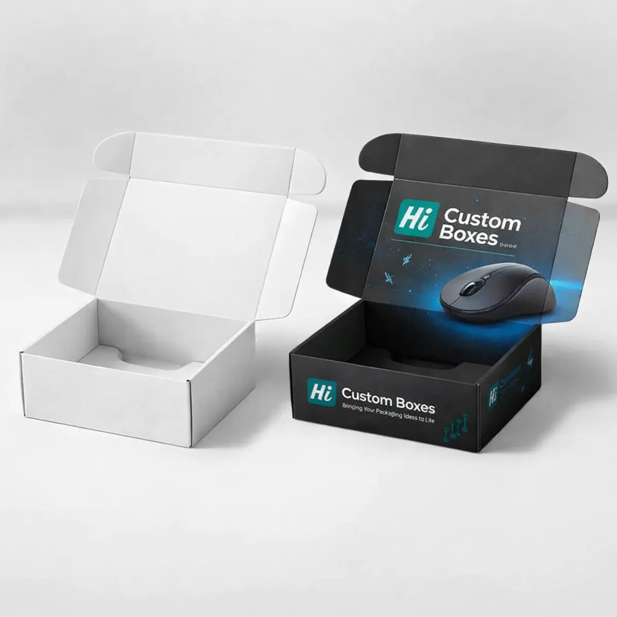 Two open mailing boxes with hinged lids; one is matte white and the other is branded black. class=